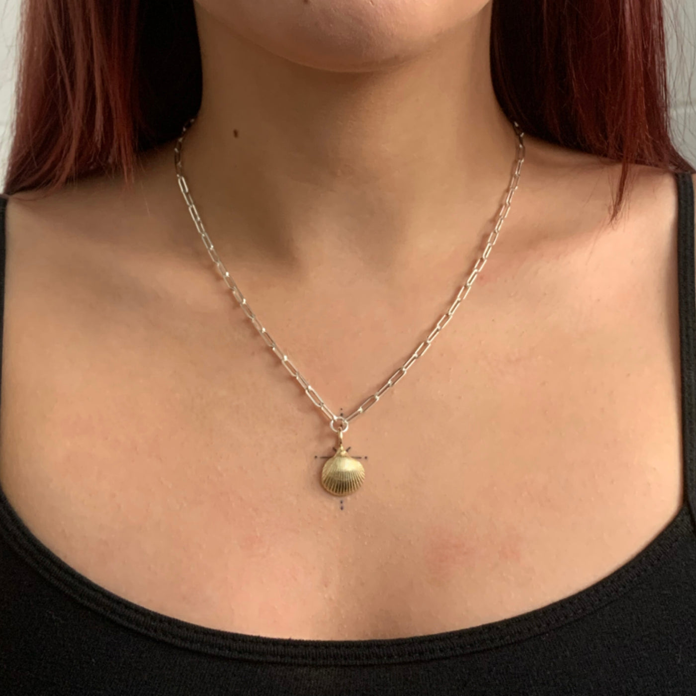 Handmade 9ct yellow gold mini clam shell charm on a recycled silver trace chain necklace from SilverBoo Jewellery in Lincolnshire